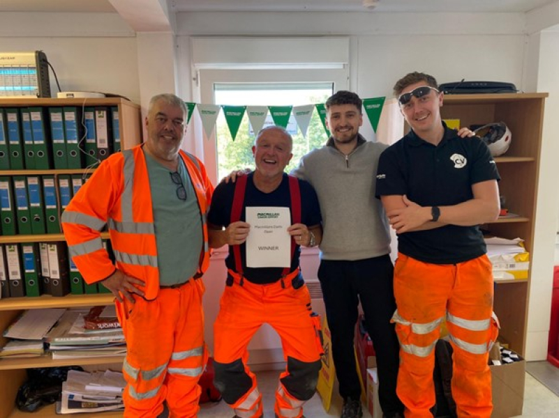 Group photo of men in orange hi vis workwear