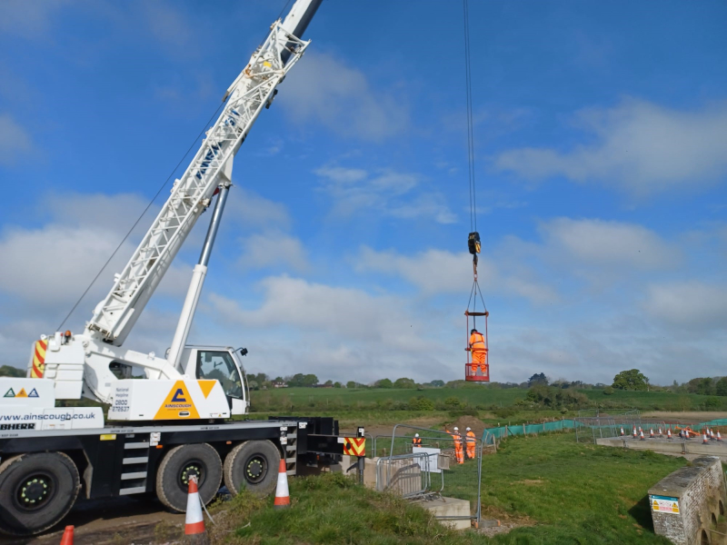 Picture of a crane lifting a gate.