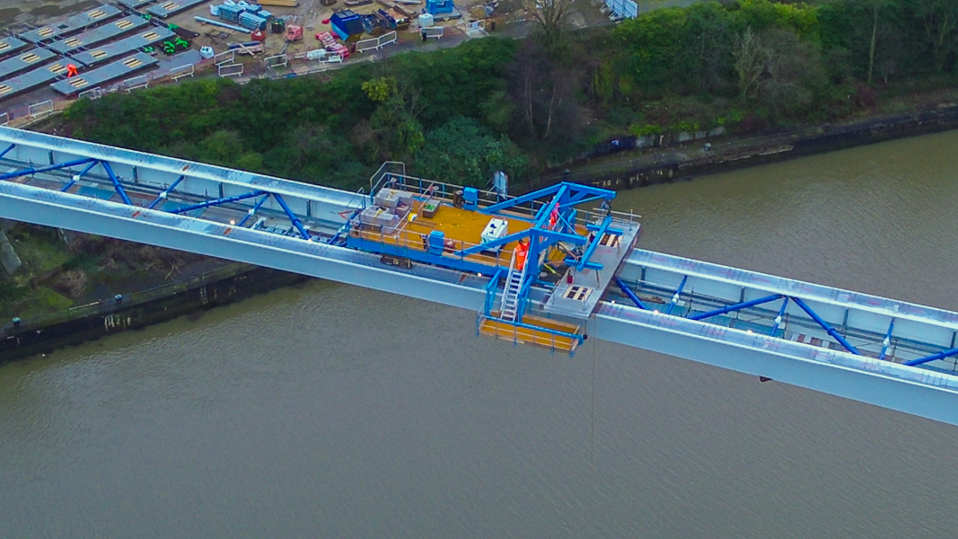 Picture of a steel bridge going across the water.