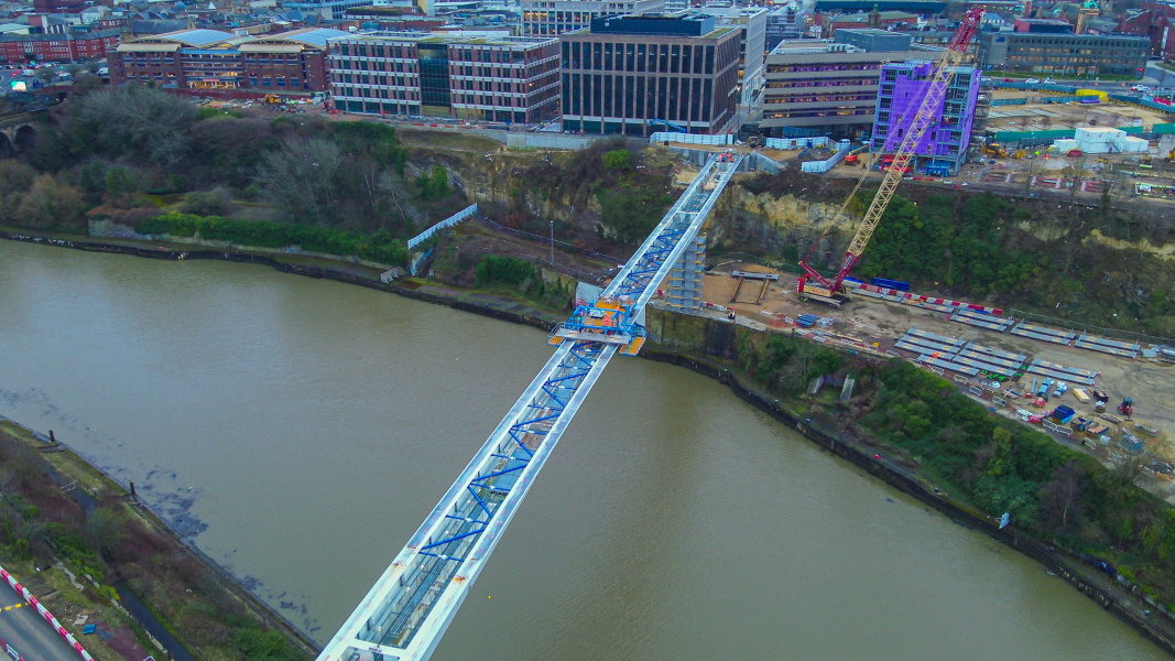 Picture of a steel bridge going across the water.