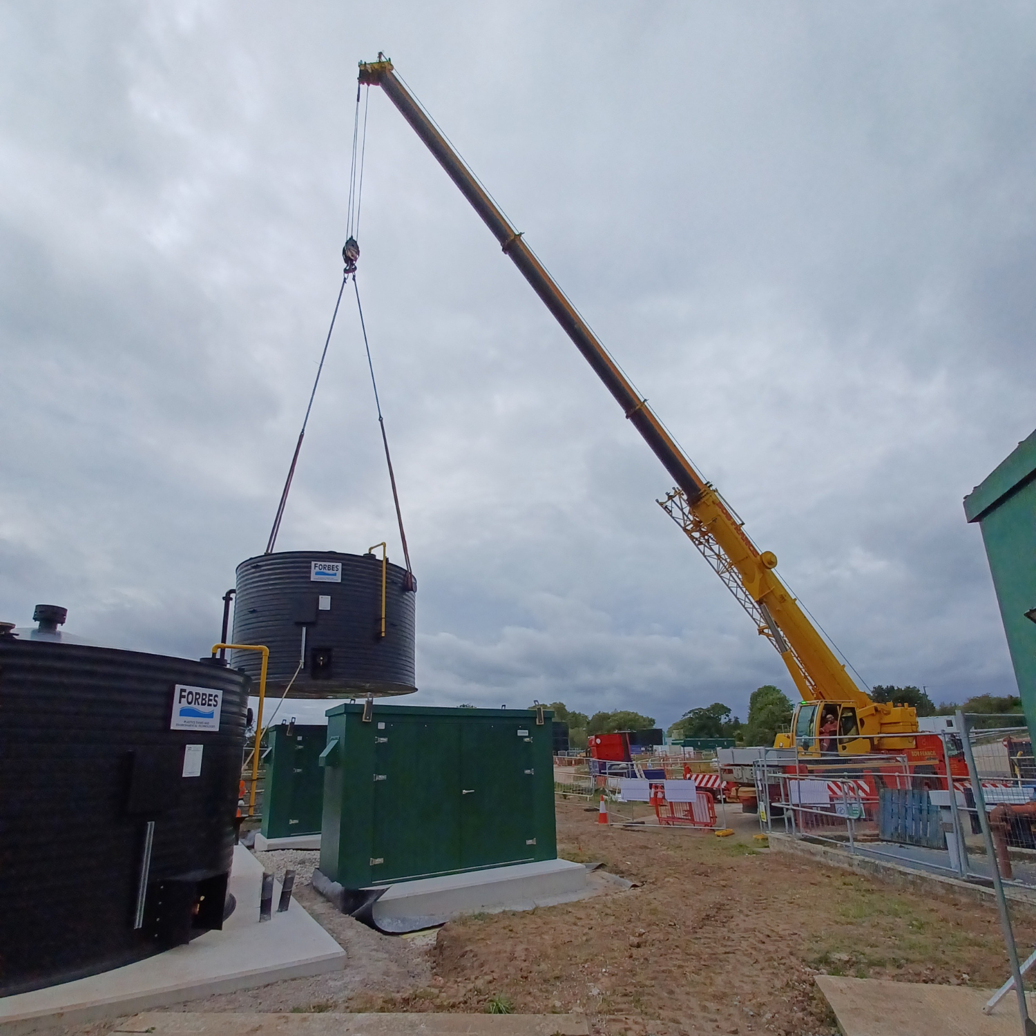 Pictures of tanks being lifted into place with a crane.