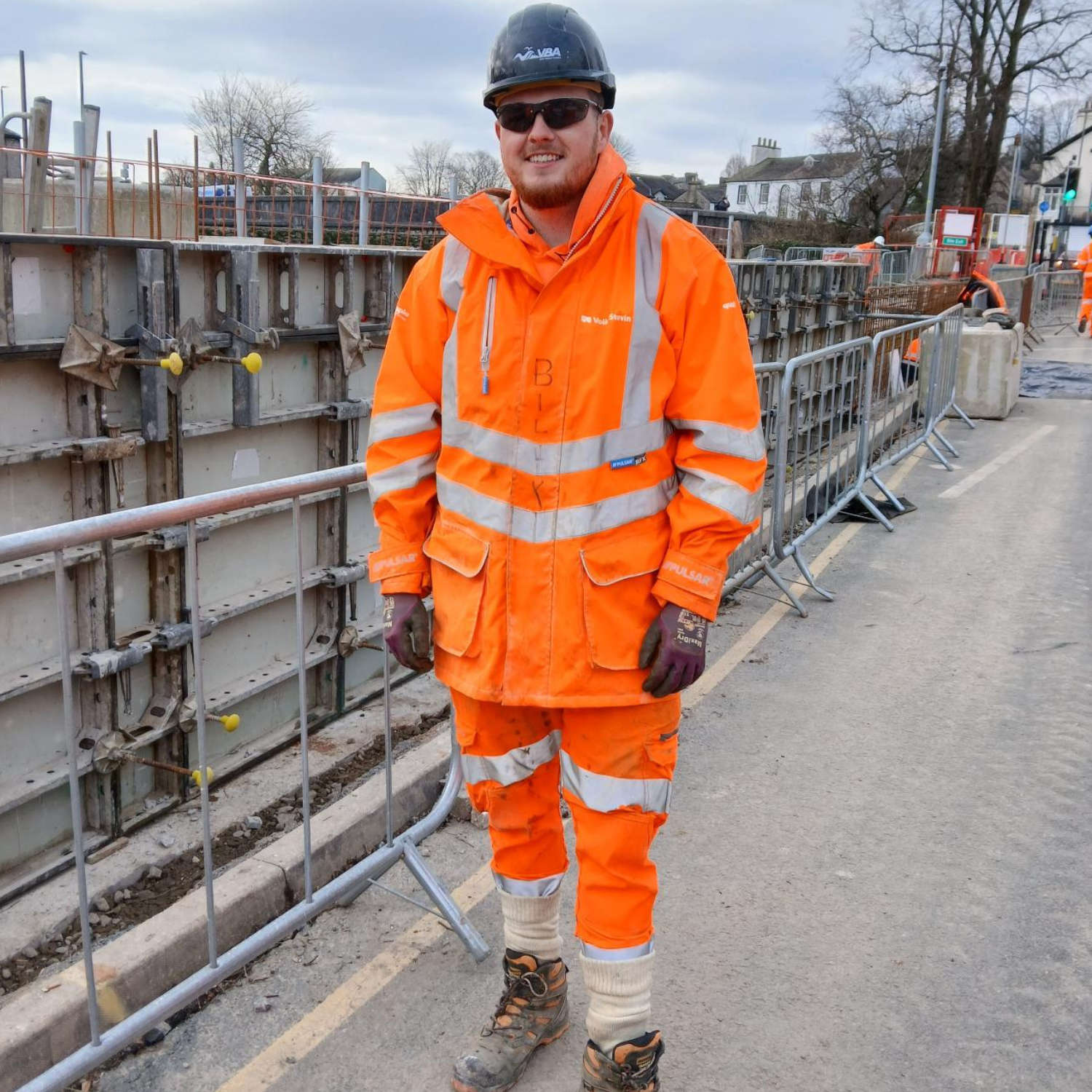 Picture of a man on site in high vis.